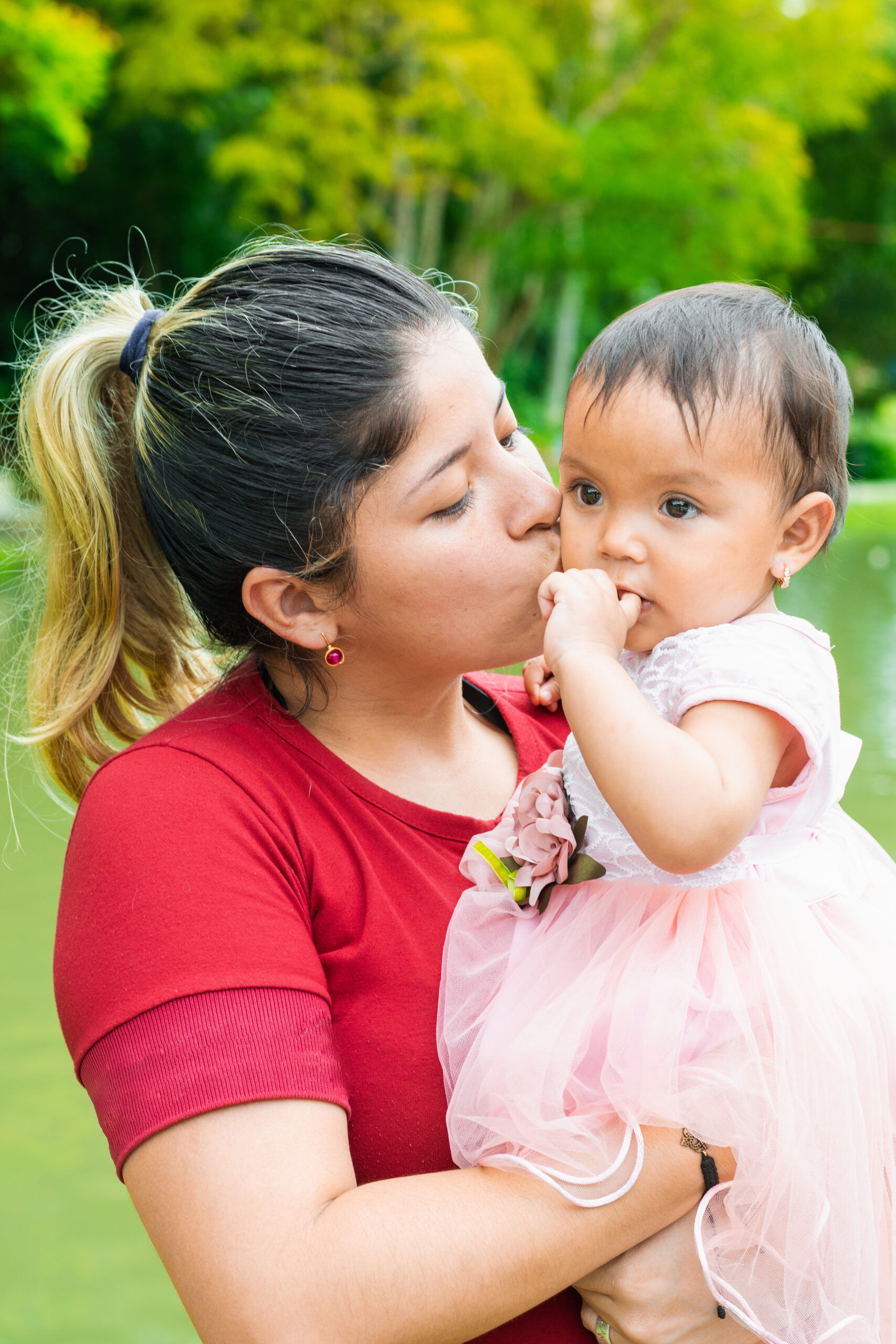 Mother kissing her baby on the cheek