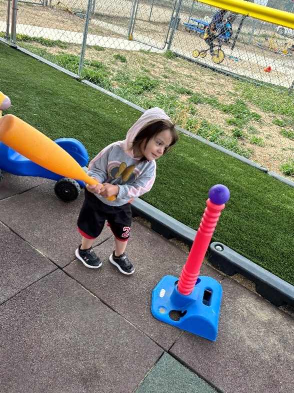 Child playing with baseball bat