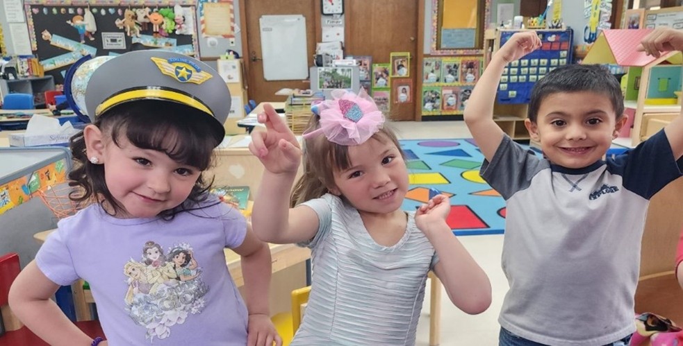 Children excitedly look and pose for picture